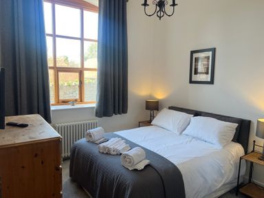 A bedroom with a double bed and chest of drawers at 4 Bickington Road Barnstaple