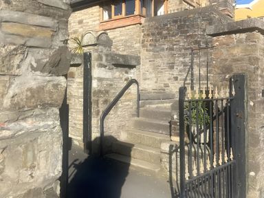 An outdoor area with stairs, a gate, and a stone wall at 4 Bickington Road Barnstaple