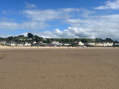 A beach with houses and hills in the background at 4 Bickington Road, Barnstaple