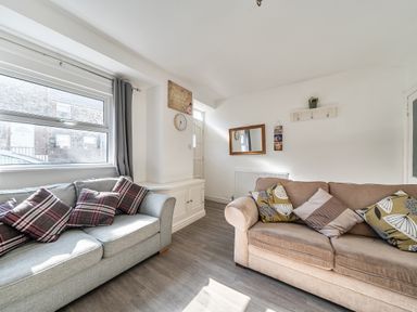 A living room with sofas and a window at Blue Haven in Penmaenmawr