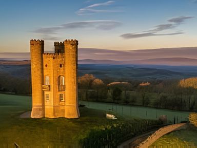 A tower in a landscape with fields and trees at Cotswold Nights Away 1 Evesham