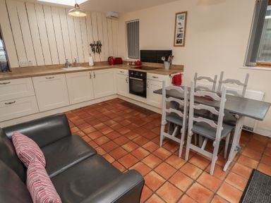A kitchen with a table and chairs at Sunny Brae in Alnwick