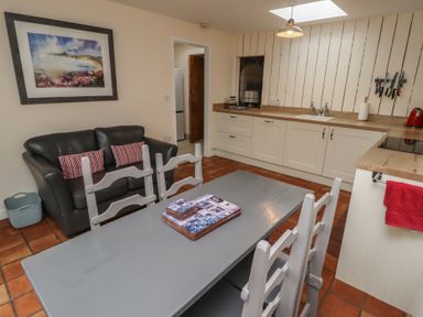 A kitchen with a table and chairs at Sunny Brae in Alnwick