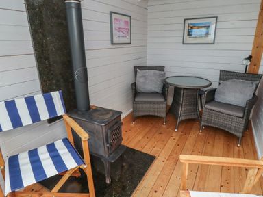 A snug with chairs and a wood stove at Sunny Brae in Alnwick