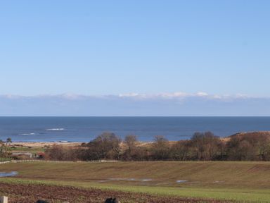 A view of the ocean and landscape at 2 Sunny Brae in Embleton
