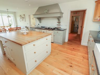 A kitchen with an island and oven at Thimble Hill near Armathwaite