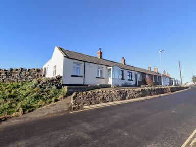 A row of houses on a street at Harry's Cottage in Embleton