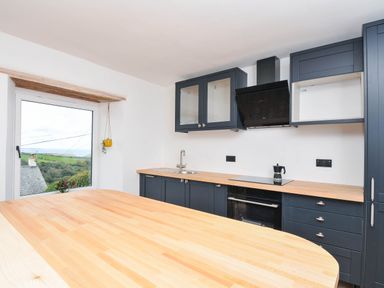 A kitchen with a sink and cabinets at Boscabrea near Tintagel