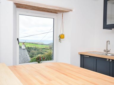 A kitchen with a window and a countertop at Boscabrea near Tintagel