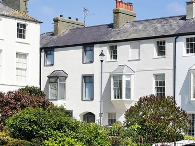 A house with windows and a garden at Tri Raglan Mawr in Beaumaris