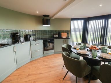 A kitchen with a dining area and appliances at Unit 1 in Ipswich