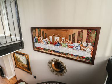 A tapestry depicting The Last Supper on a wall in the stairway at Unit 1 Ipswich