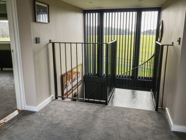 A staircase with a handrail in a hallway at Unit 1 Ipswich