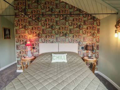 A bedroom with a bed and decorative wall art at Unit 1 Ipswich