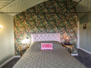 A bedroom with a bed and bedside tables at Unit 1 Ipswich