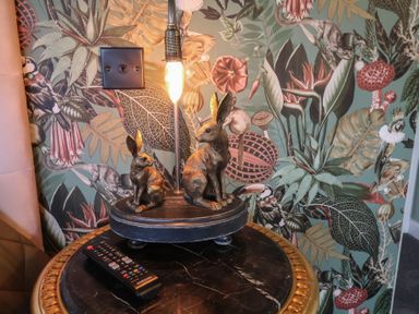 A lamp featuring rabbit figurines in a living room at Unit 1 in Ipswich