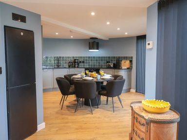 A kitchen with a table and chairs at Unit 2 Ipswich