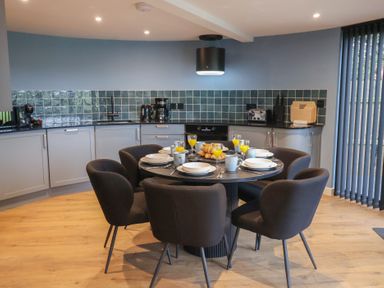 A kitchen with a dining table and chairs at Unit 2 in Ipswich