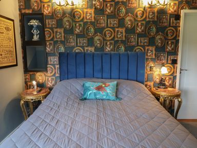 A bedroom with a bed and decorative wall at Unit 2 Ipswich