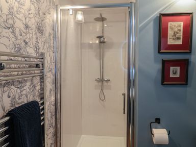 A bathroom with a shower and towel rack at Unit 2 Ipswich
