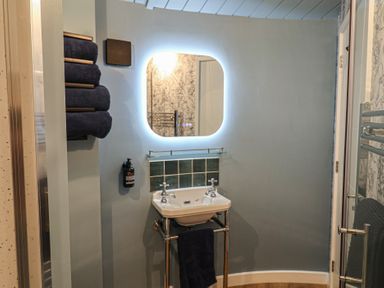 A bathroom with a sink and towels at Unit 2 in Ipswich