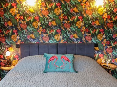 A bedroom with a bed and colorful wallpaper at Unit 2 in Ipswich