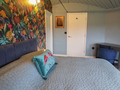 A bedroom with a bed and desk at Unit 2 in Ipswich