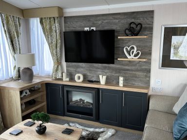A living room with a television and fireplace at TW89 in Exmouth