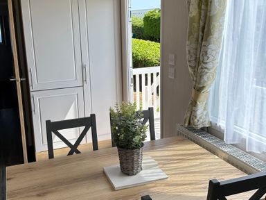 A dining room with table and chairs at TW89 in Exmouth