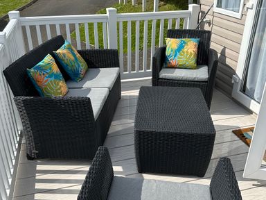 An outdoor sitting area with furniture at TW89 Exmouth