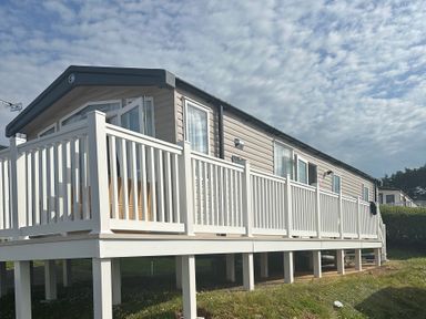 A mobile home with a deck at TW89 Exmouth