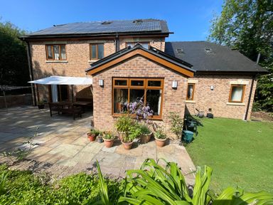 A house with a garden and patio at Ty-Gan Dderwen in Llangennech