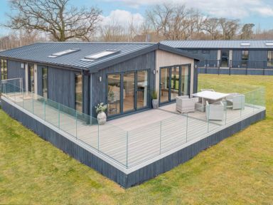 A lodge with decking and outdoor seating at Isca Lodge - With Decking - Lodge 1 Wombleton