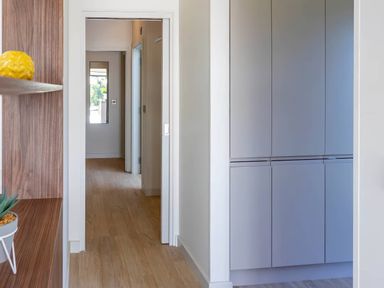 A hallway with a cabinet and a plant pot at Rye Lodge in Wombleton