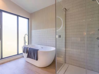 A bathroom featuring a bathtub and shower at Rye Lodge in Wombleton