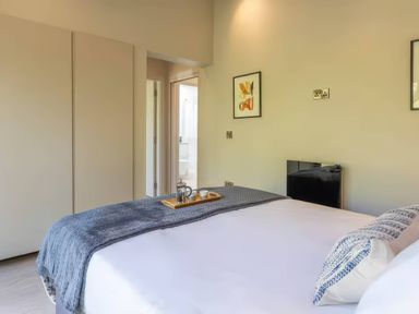 A bedroom with a bed and artwork at Rye Lodge in Wombleton