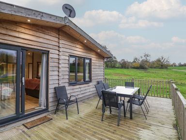 A deck with a table and chairs at Oak Lodge Admaston near Abbots Bromley
