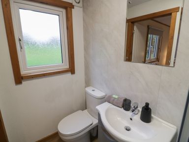 A bathroom with a sink and toilet at Oak Lodge Admaston near Abbots Bromley