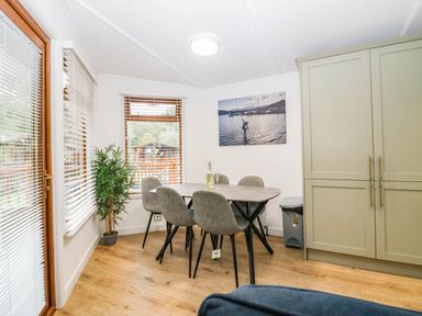 A dining room with a table and chairs at Terabitha Lodge in Troutbeck