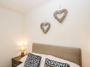 A bedroom with a bed and decorative hearts at Terabitha Lodge in Troutbeck