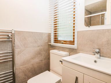 A bathroom with a toilet and sink at Terabitha Lodge Troutbeck