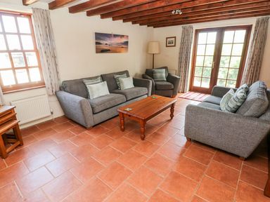 A living room with sofas and a coffee table at Ty Fferm in Newport