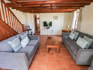 A living room with two sofas and a coffee table at Ty Fferm in Newport