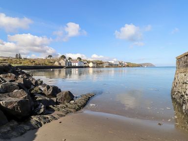 A coastal view with rocks and water at Ty Fferm in Newport