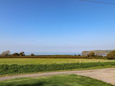 A view of the sea and hills with fields at Ty Felin in Newport