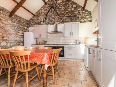 A kitchen with table and chairs at Ty Felin in Newport