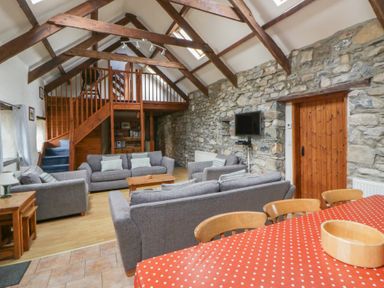 A living room with sofas and a dining table at Ty Felin in Newport, Pembrokeshire