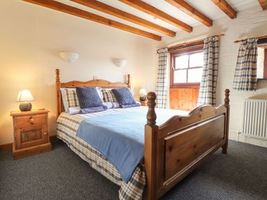 A bedroom with a bed and nightstand at Ty Gwartheg in Newport
