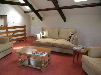 A living room with a sofa and coffee table at Ty Cariad in Newport