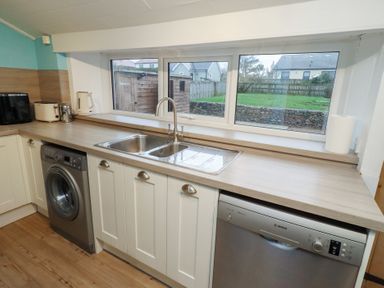 A kitchen with sink and appliances at Braeburn in Bamburgh